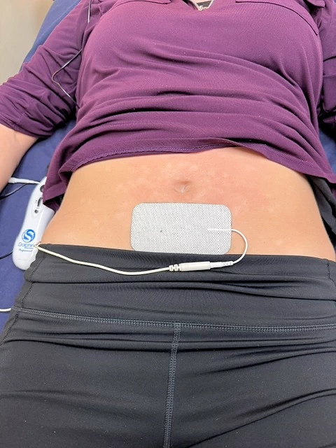 Dolphin Neurostim device and skin-contact accessories positioned during a treatment session.